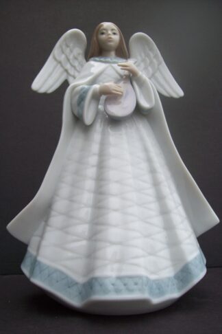 Porcelain angel figurine holding a lute.