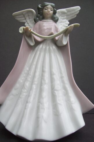 Porcelain angel figurine holding a scroll.