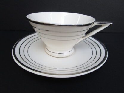 White teacup and saucer with silver trim.