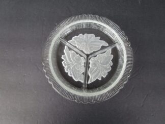 Clear glass serving dish with floral design.