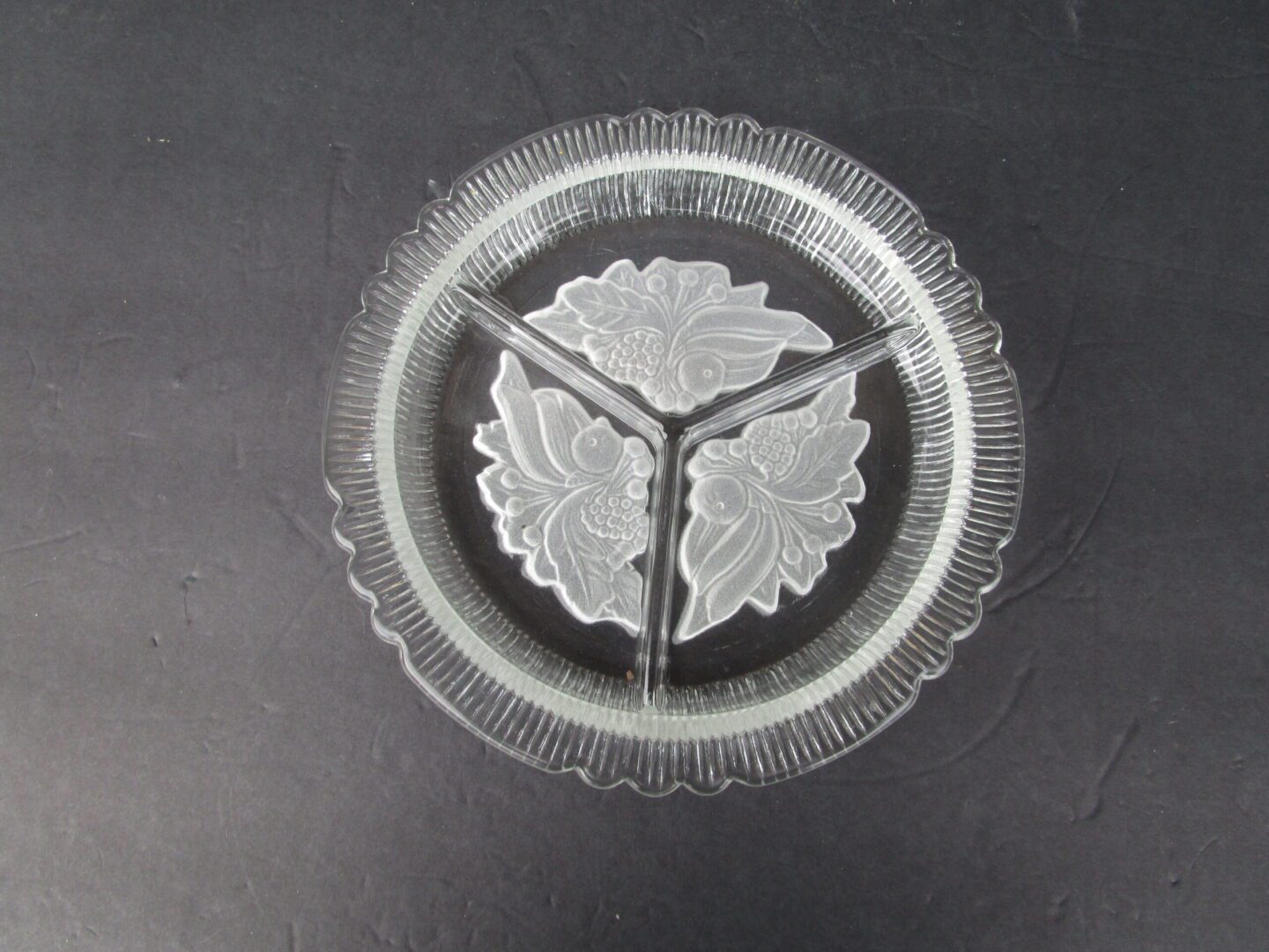 Clear glass serving dish with floral design.