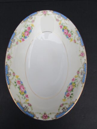 White floral serving bowl with gold trim.