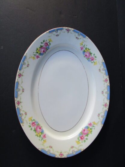 White oval plate with floral border.