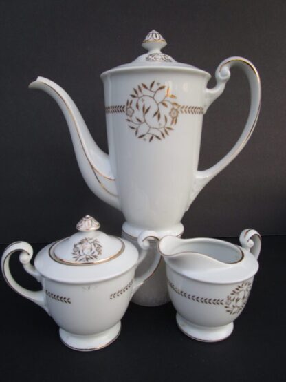 White porcelain teapot, sugar bowl and creamer.