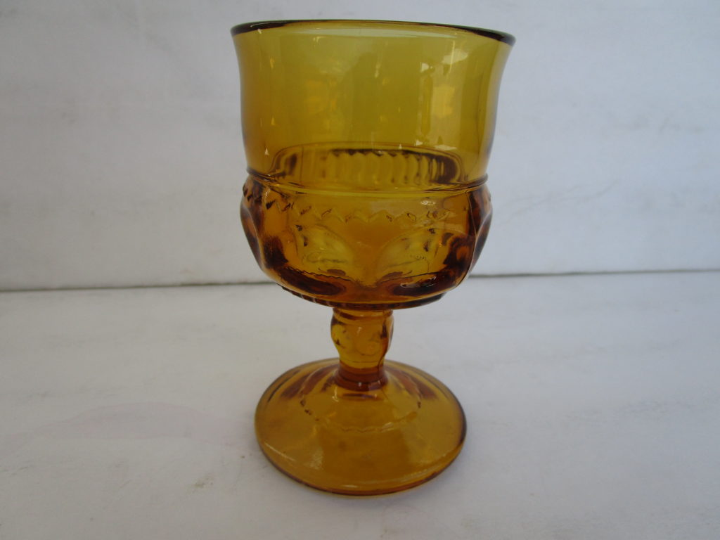 Close shot of Amber color Designer glass with circular base