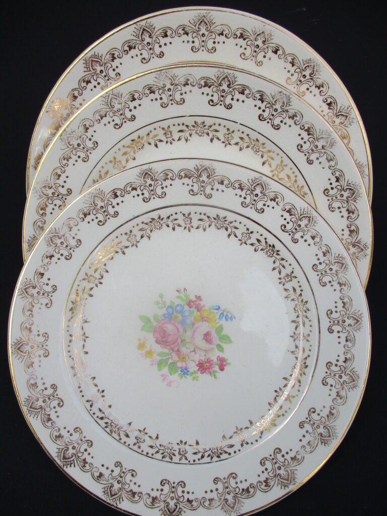 A set of four plates with flowers on them.