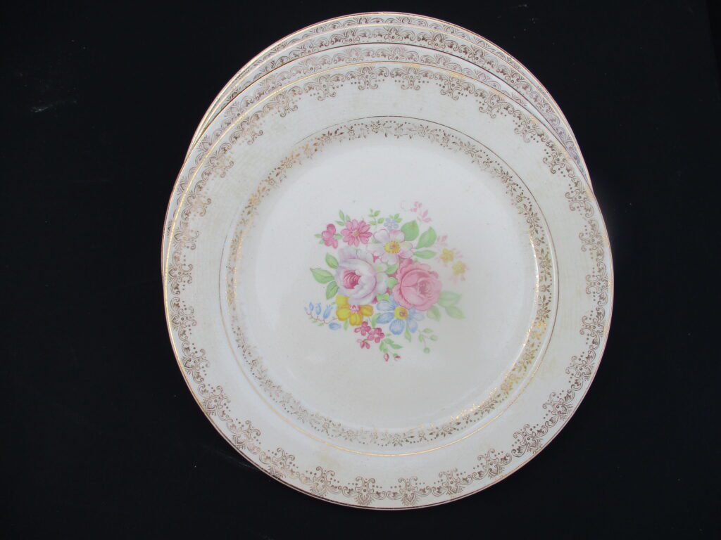 A set of three plates with flowers on them.