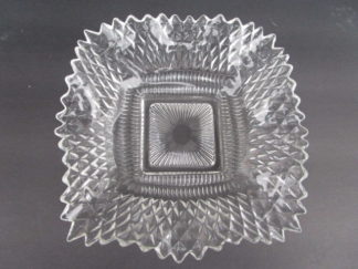 an elegant and sparkling crystal clear ruffled square bowl