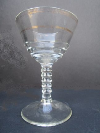 Wine glass with two gold rings around the cup
