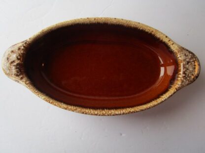 Brown and white glazed oval baking dish.