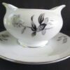 White gravy boat with black rose design.