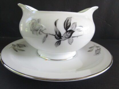 White gravy boat with black rose design.