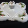 A white dish with flowers and leaves on it.