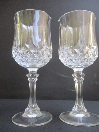 Two wine glasses are sitting on a table.