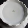 A white plate with a green logo on it
