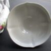 A white bowl sitting on top of a table.