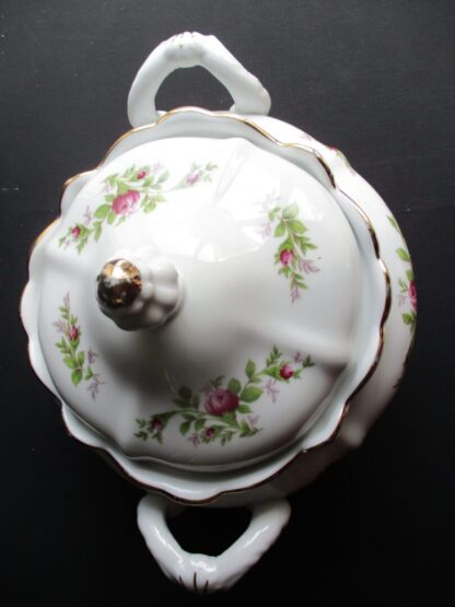 A white bowl with pink flowers on it