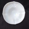 A white bowl sitting on top of a table.