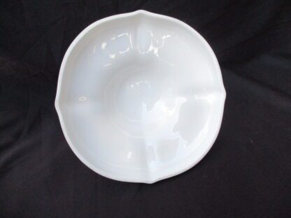 A white bowl sitting on top of a table.