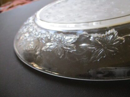 A silver plate with leaves on it